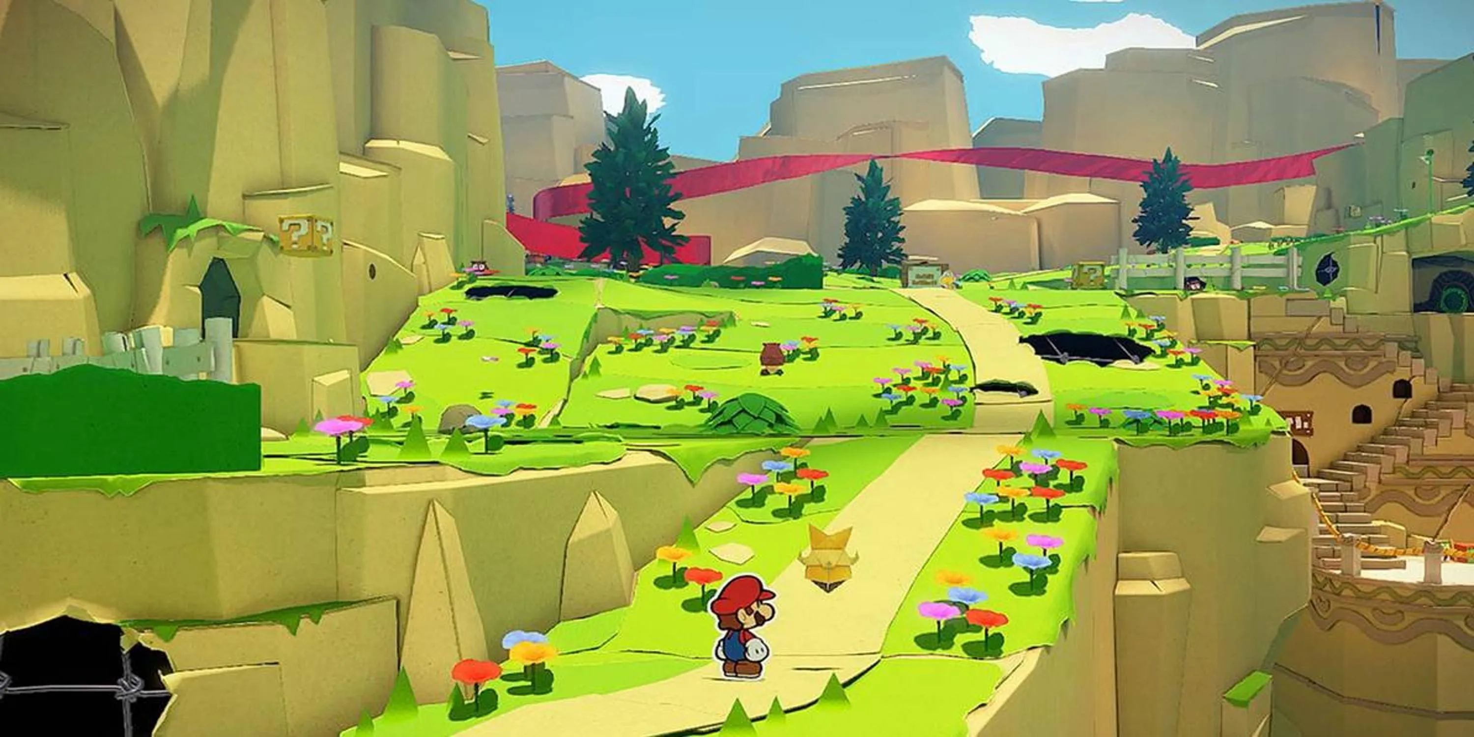 Mario đứng trên con đường dẫn lên đồi trong Paper Mario The Origami King, minh họa đồ họa độc đáo của game