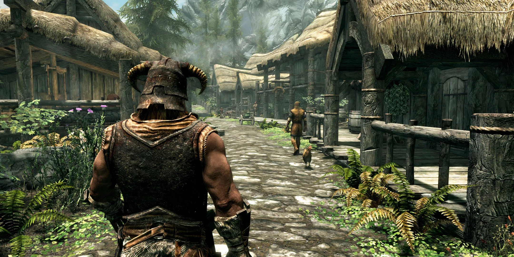 Nhân vật chính đang đi bộ qua một thị trấn yên bình trong Skyrim, tựa game hay mà nhiều game thủ vô tình bỏ dở giữa chừng.
