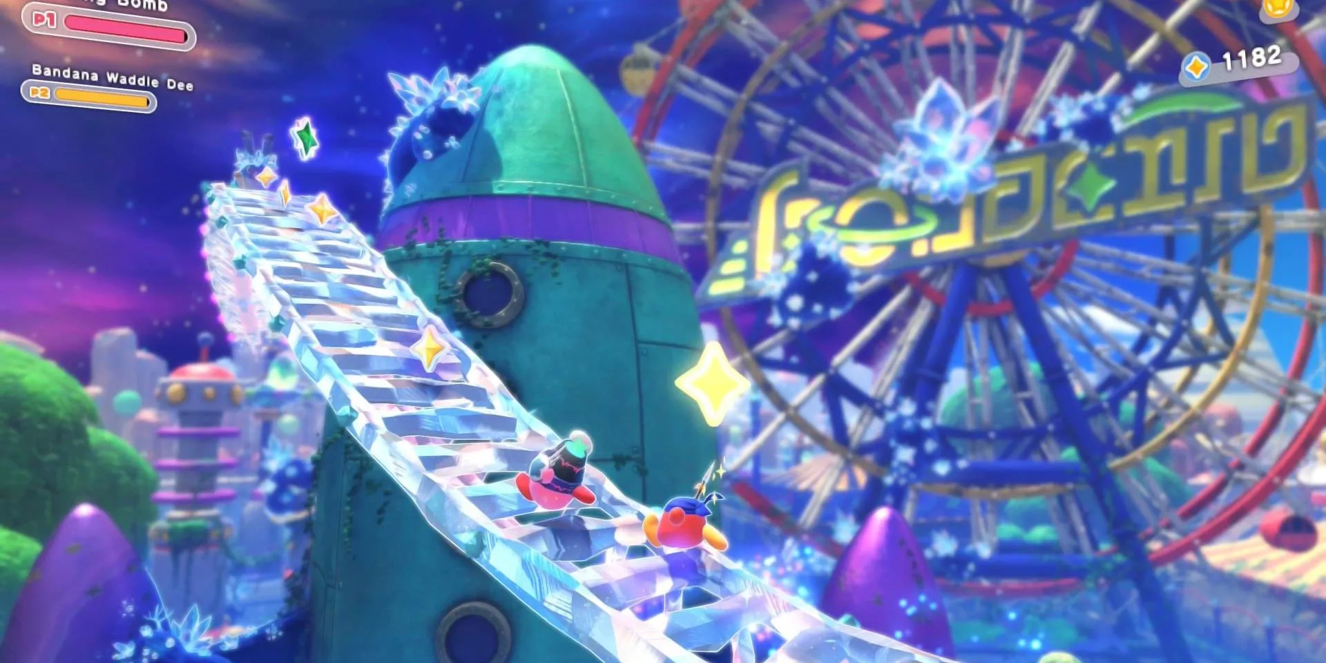 Kirby cạnh vòng quay Ferris Wheel khổng lồ trong Kirby: Star-Crossed World, thể hiện môi trường được cải tiến.